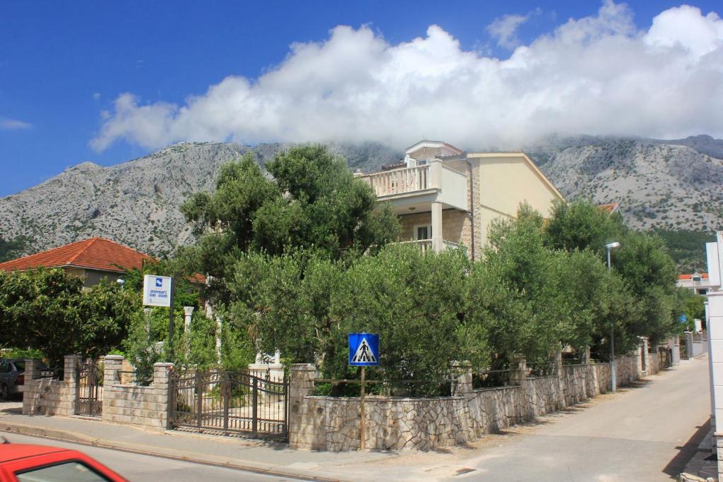 un edificio sul lato di una strada alberata di Apartments and rooms with parking space Orebic, Peljesac - 10085 a Orebić (Sabbioncello)