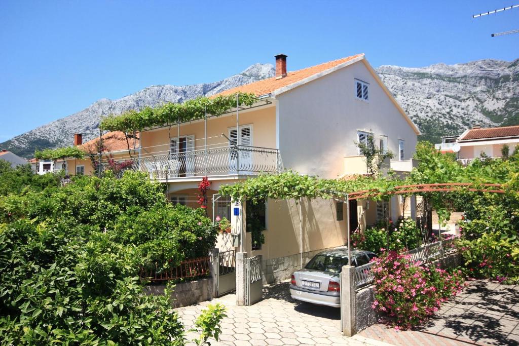 a house with a car parked in front of it at Apartments with a parking space Orebic, Peljesac - 10159 in Orebić