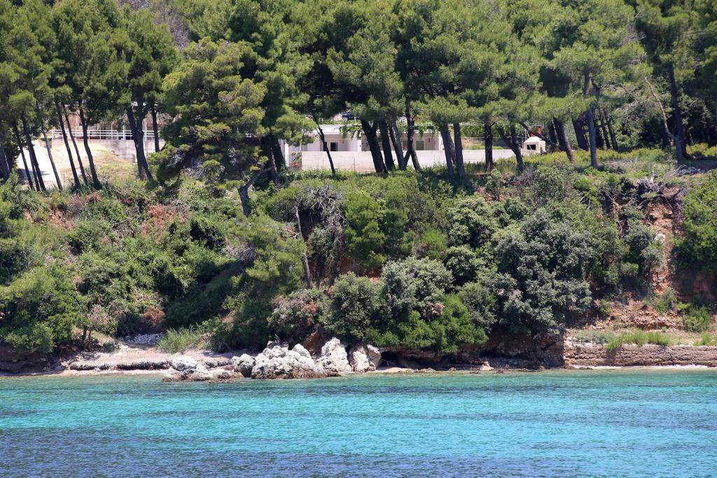 a small island in the middle of a body of water at Apartments by the sea Zuljana, Peljesac - 10207 in Žuljana