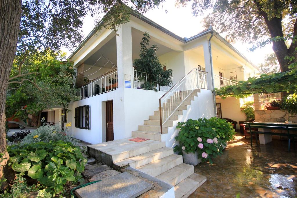 a white house with stairs in front of it at Apartments with a parking space Orebic, Peljesac - 10171 in Orebić