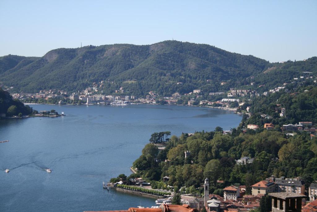 a view of a lake with a town and mountains at Casa Rossa - byMyHomeinComo in Cernobbio