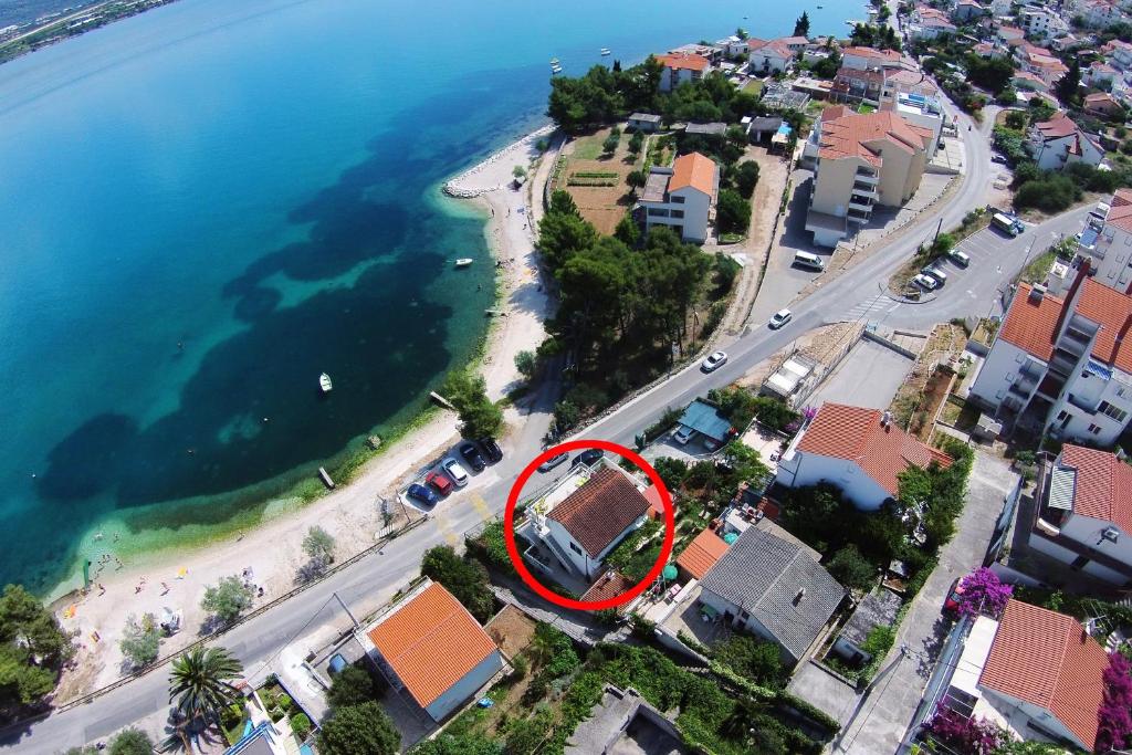 an aerial view of a beach with a red circle at Apartment Mastrinka 10261b in Trogir