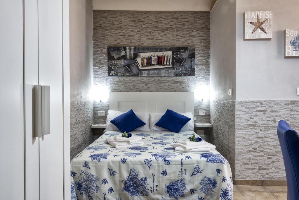 a bedroom with a blue and white bed with blue pillows at Stella Maris in Syracuse