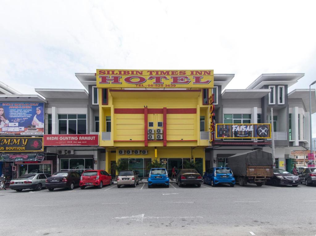 a hotel with cars parked in a parking lot at Silibin Times Inn Hotel in Ipoh