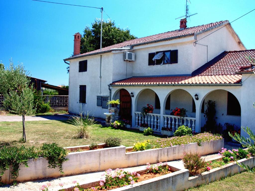 a white house with a red roof at Apartments and rooms with parking space Zambratija, Umag - 11875 in Zambratija