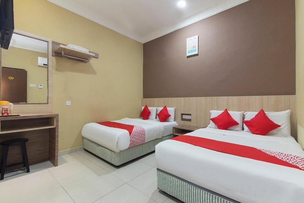 Postel nebo postele na pokoji v ubytování Silibin Times Inn Hotel