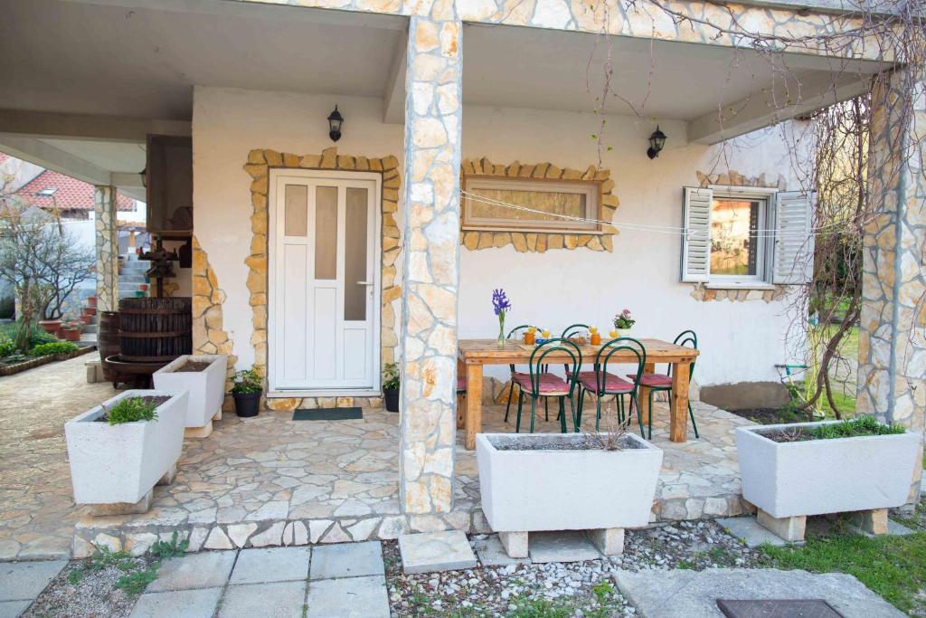 un patio con mesa y sillas en una casa en Apartments by the sea Zuljana, Peljesac - 12058 en Žuljana
