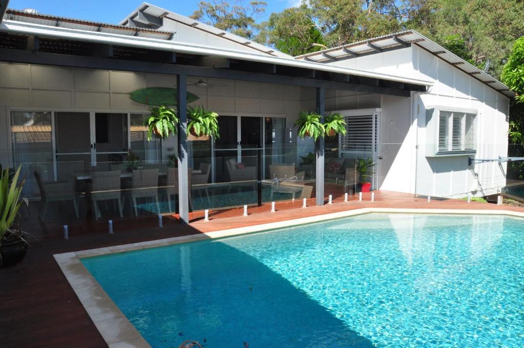 a swimming pool in front of a house at Double 10 in Rainbow Beach