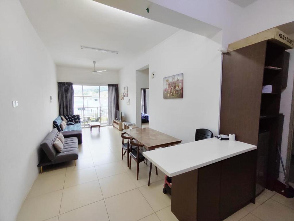 a kitchen and living room with a couch and a table at Cameron 3room Golden Hills in Brinchang