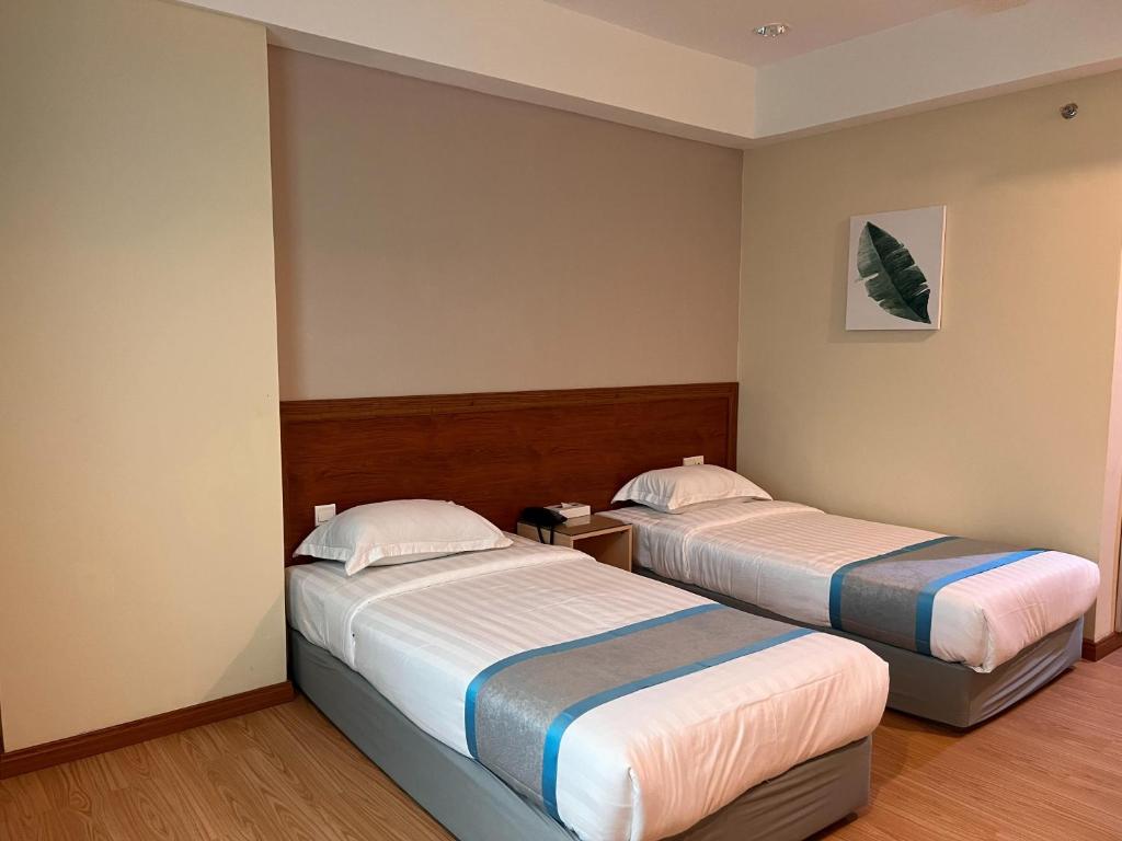 Postel nebo postele na pokoji v ubytování TD CAPITAL HOTEL