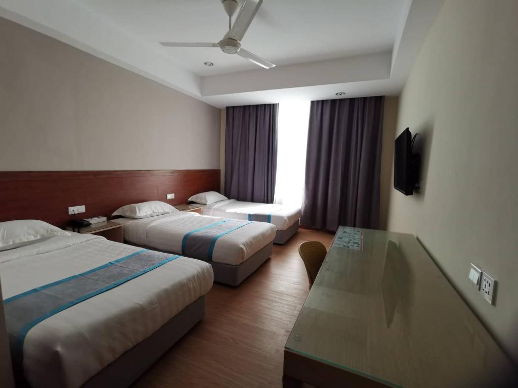 Postel nebo postele na pokoji v ubytování TD CAPITAL HOTEL