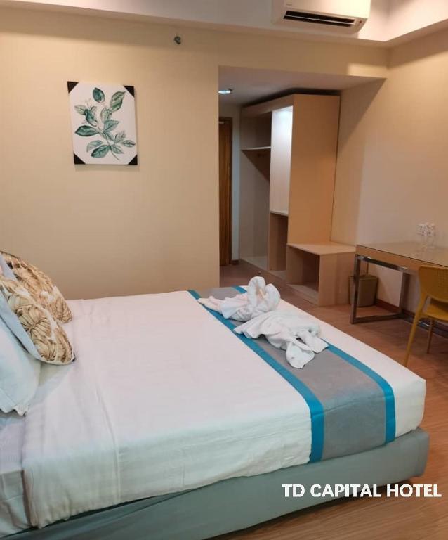 Postel nebo postele na pokoji v ubytování TD CAPITAL HOTEL