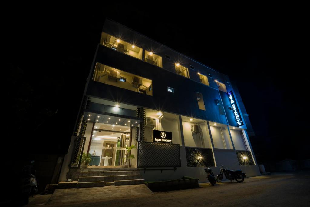 a building with lights on it at night at Jeyam Residency in Puducherry