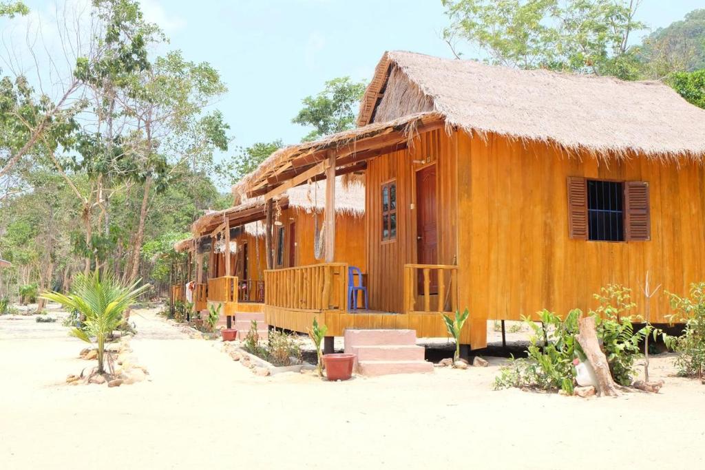 a wooden house with a porch and stairs in front at Mangrove Beach Bungalows in Koh Rong Sanloem