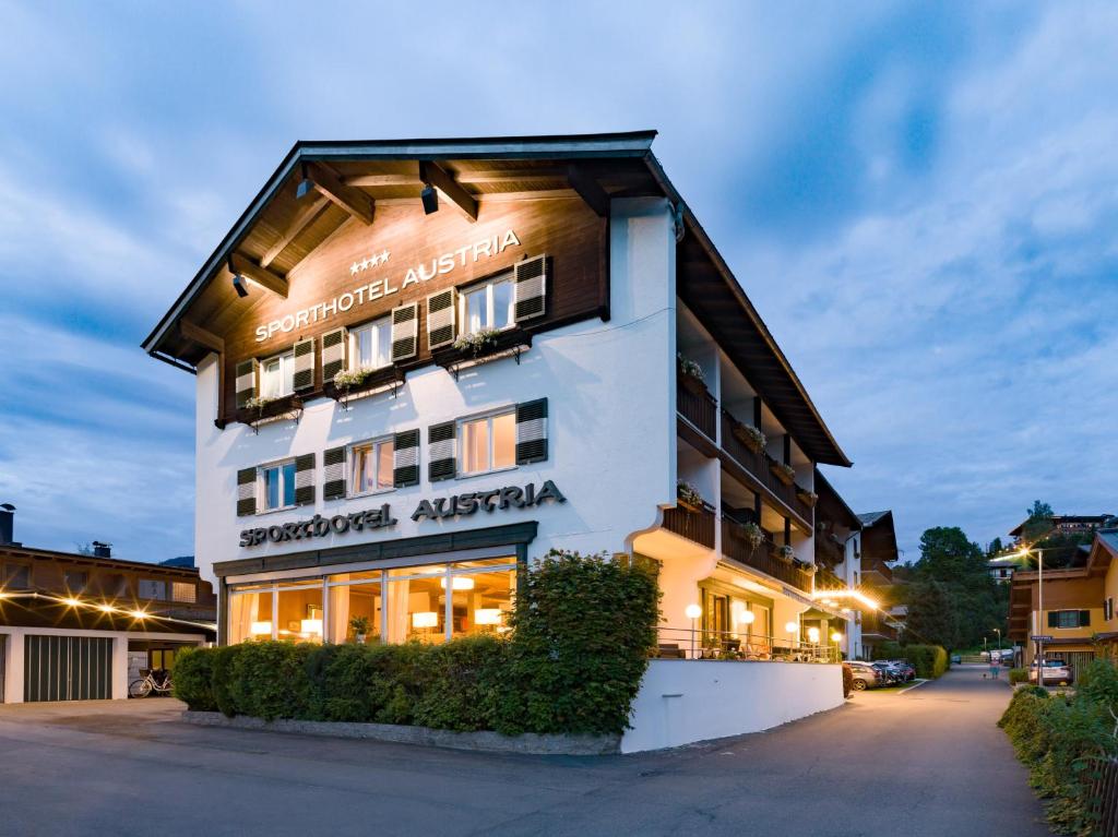 a building with a sign on the side of it at Sporthotel Austria in Sankt Johann in Tirol