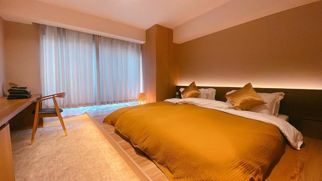 a bedroom with a large yellow bed with a window at ICHIYU HOTEL ASAKUSA in Tokyo