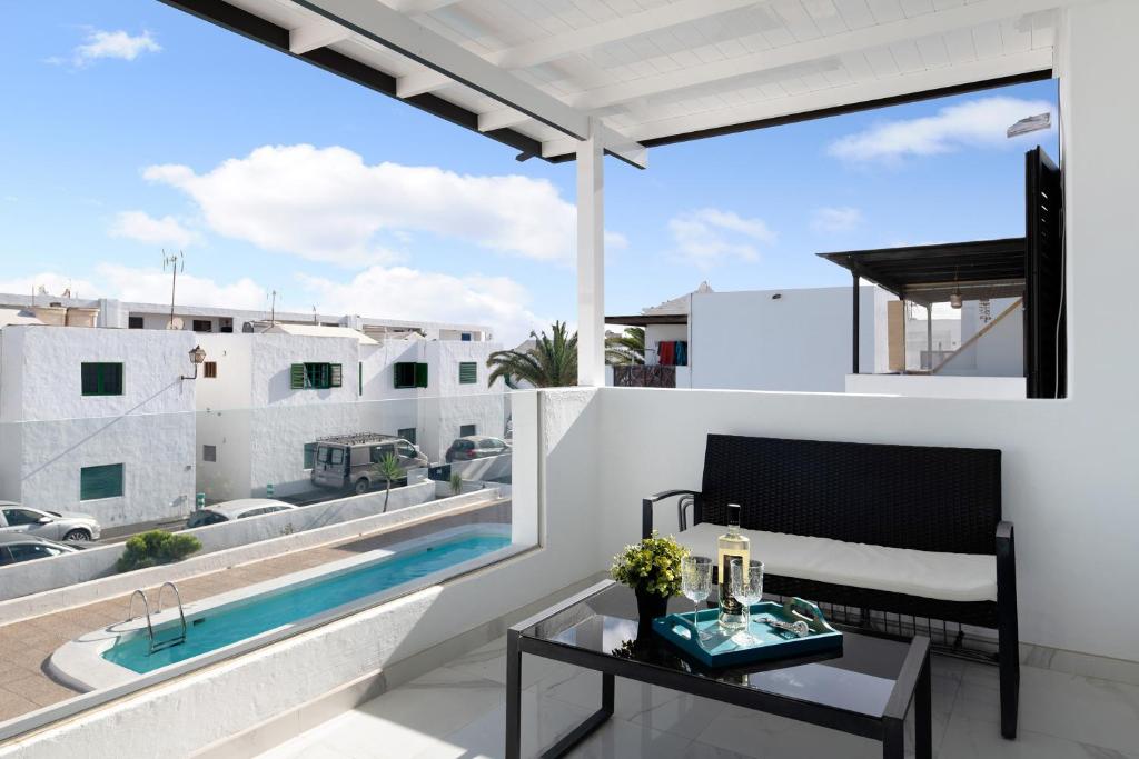 a view from the balcony of a house with a swimming pool at Casa Fariones in Puerto del Carmen