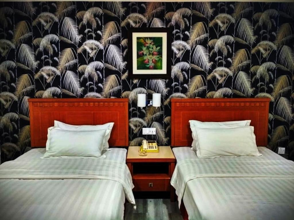 a bedroom with two beds and a wall mural at D'Borneo Hotel in Kota Kinabalu