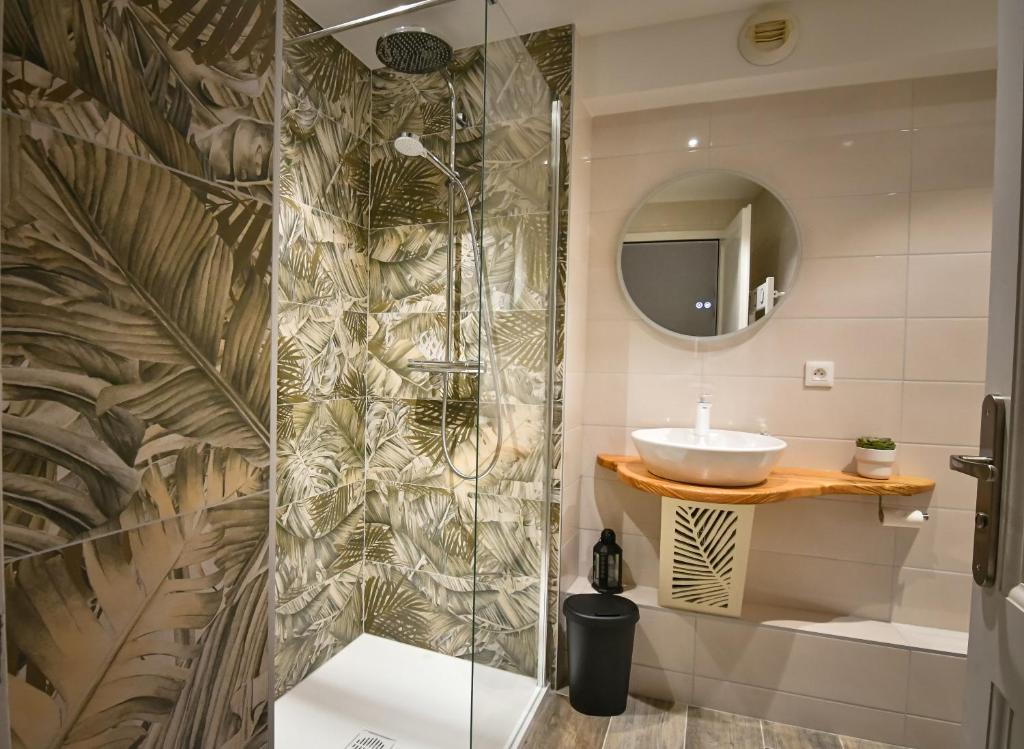 a bathroom with a shower and a sink at Au Fil du Temps in Sélestat