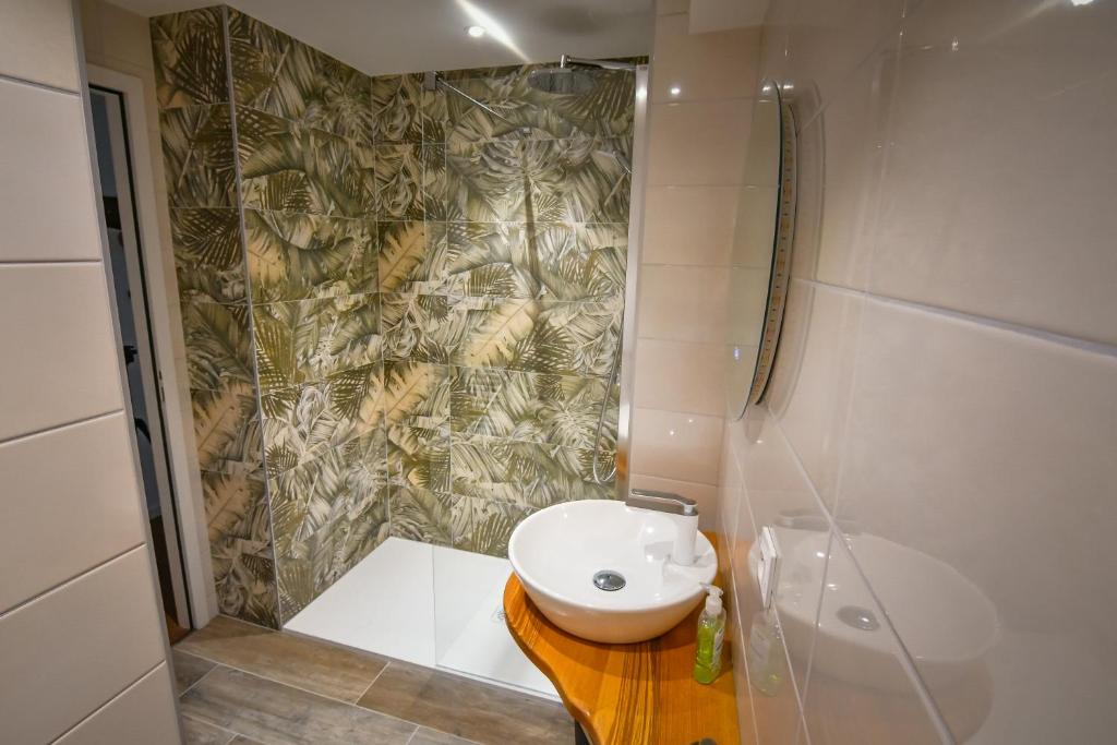 a bathroom with a toilet and a shower and a sink at Au Fil du Temps in Sélestat