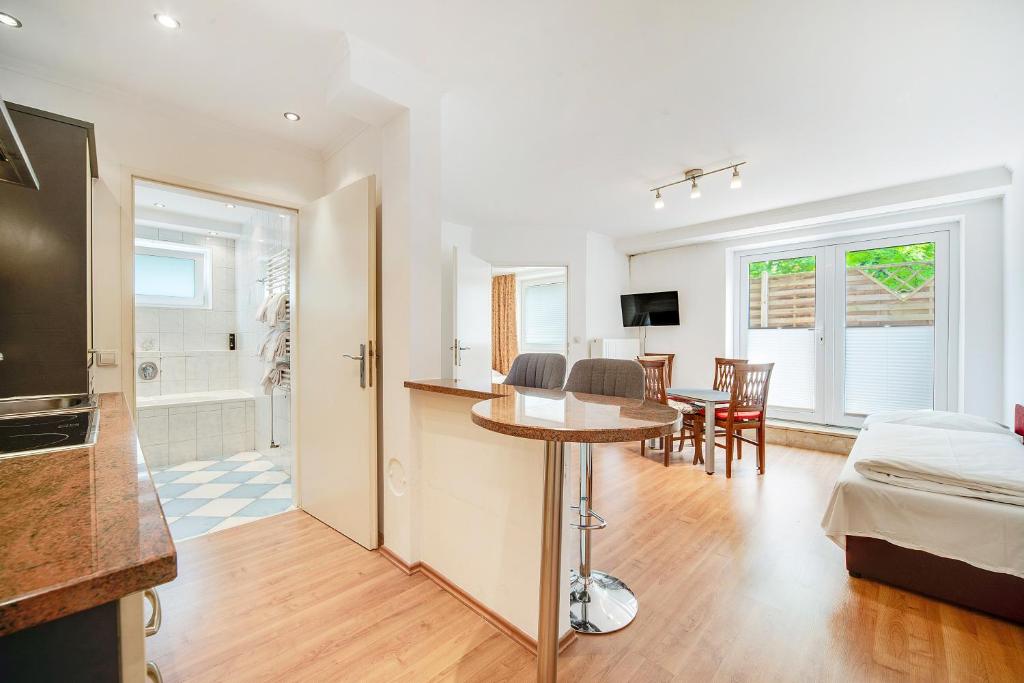 a living room with a kitchen and a dining room at Appartment Maxglan in Salzburg