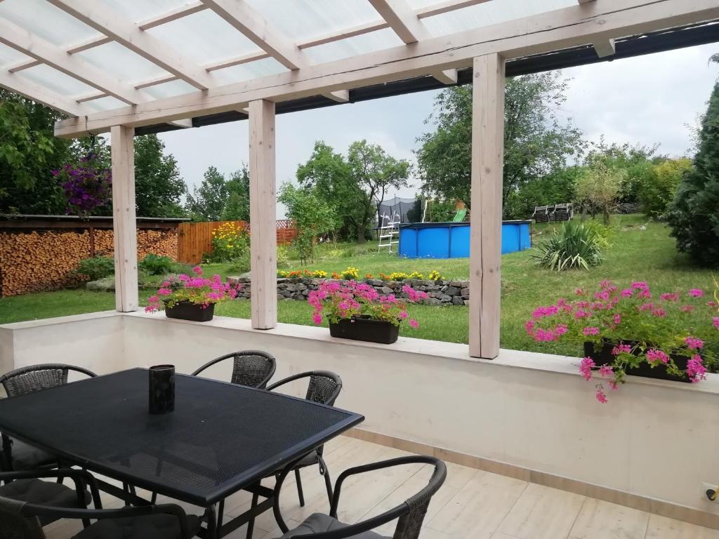 a patio with a table and chairs and flowers at Apartment Těchov in Blansko