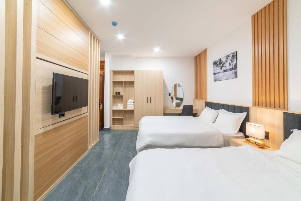 Postel nebo postele na pokoji v ubytování Quốc Khánh Condotel