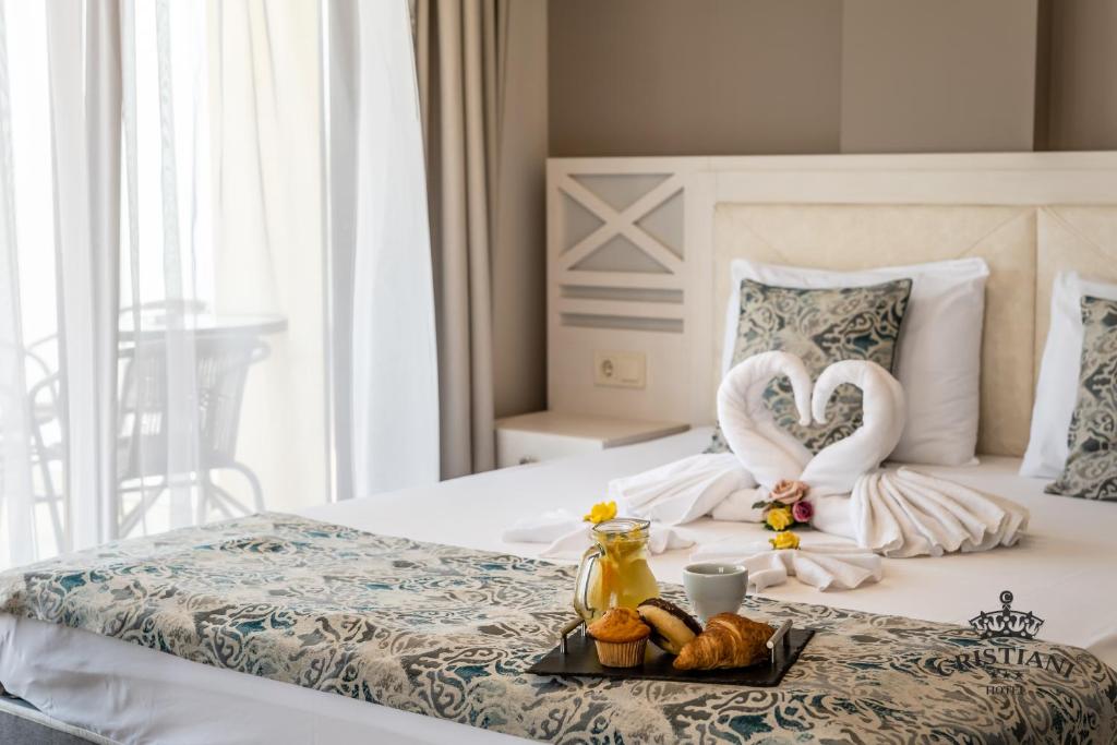 A bed or beds in a room at Cristiani Hotel Sozopol