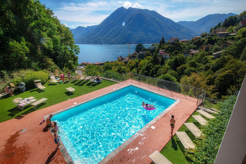 a swimming pool with a view of a mountain at EASYLIFE - Como - Crotta 3 - Argegno in Argegno