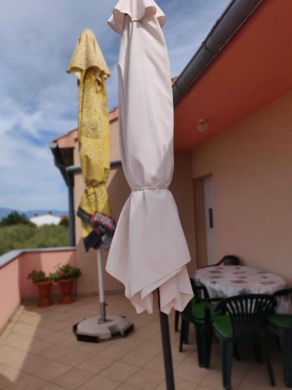 a robe on a pole on a patio at Apartment Nenadic in Hrahorić
