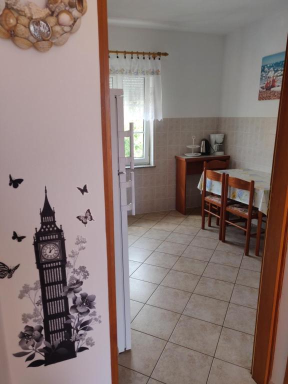 a room with a clock and butterflies on the wall at Apartment Nenadic in Hrahorić