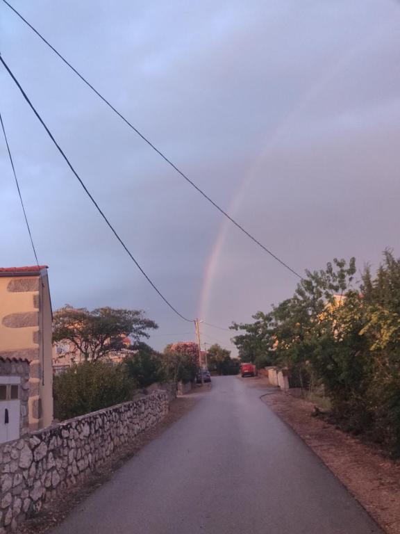a rainbow in the sky over a road at Apartment Nenadic in Hrahorić