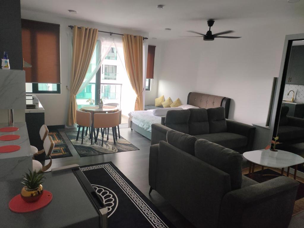 a living room with a bed and a living room with a couch at Nur Mateen's Studio - Vista Bangi Service Apartment in Kajang