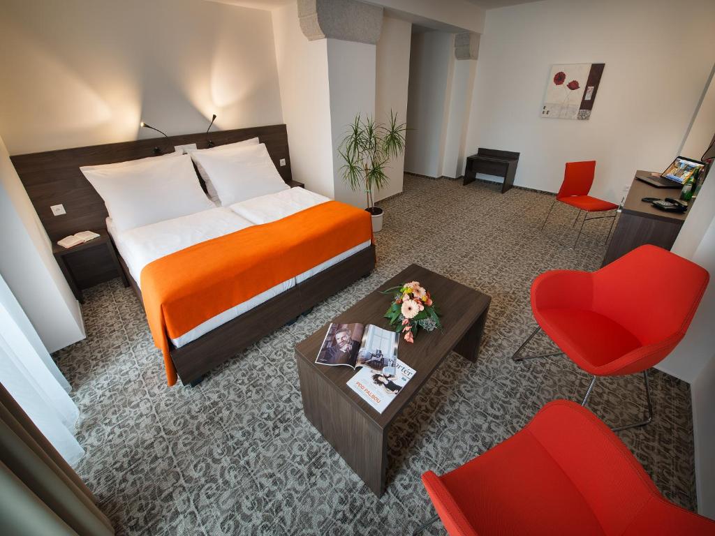 Postel nebo postele na pokoji v ubytování EA Business Hotel Jihlava