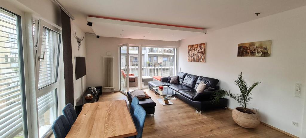 a living room with a couch and a table at Luxuswohnung mit Weserblick nähe City in Bremen