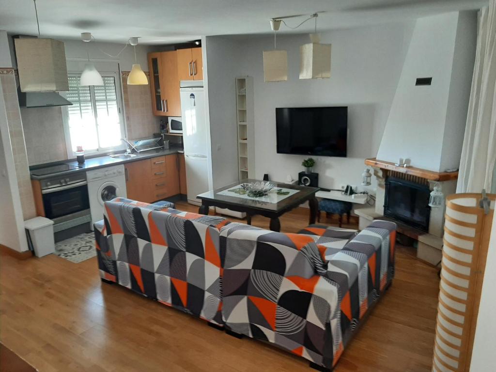 a living room with a couch and a table at El Mirador de la Sierra in Benaocaz