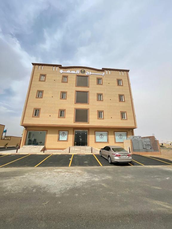 a building with a car parked in a parking lot at شقق برج السمو للشقق المفروشة in Najran