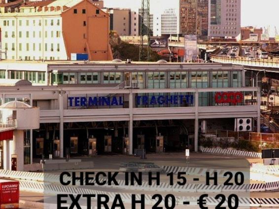 a building with a sign on it in a city at Hotel Guesthouse MASSENA in Genova