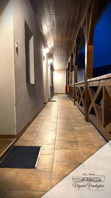 a hallway of a building with a tile floor at Végvári Vendégház in Magyarbóly