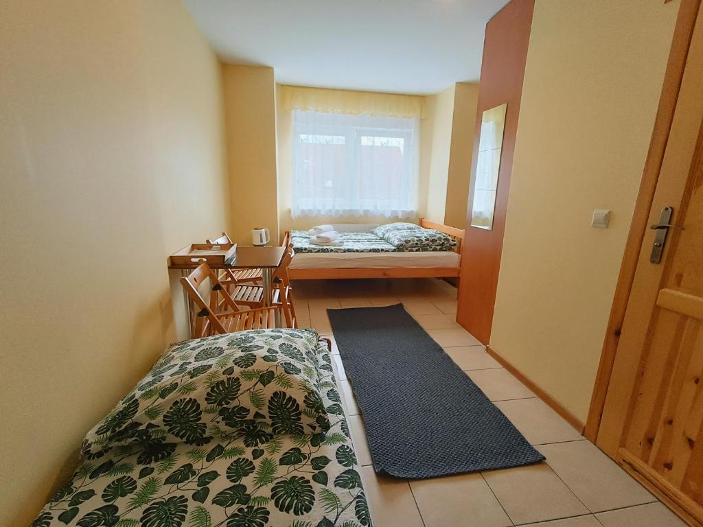 Postel nebo postele na pokoji v ubytování Dom Gościnny Piotr