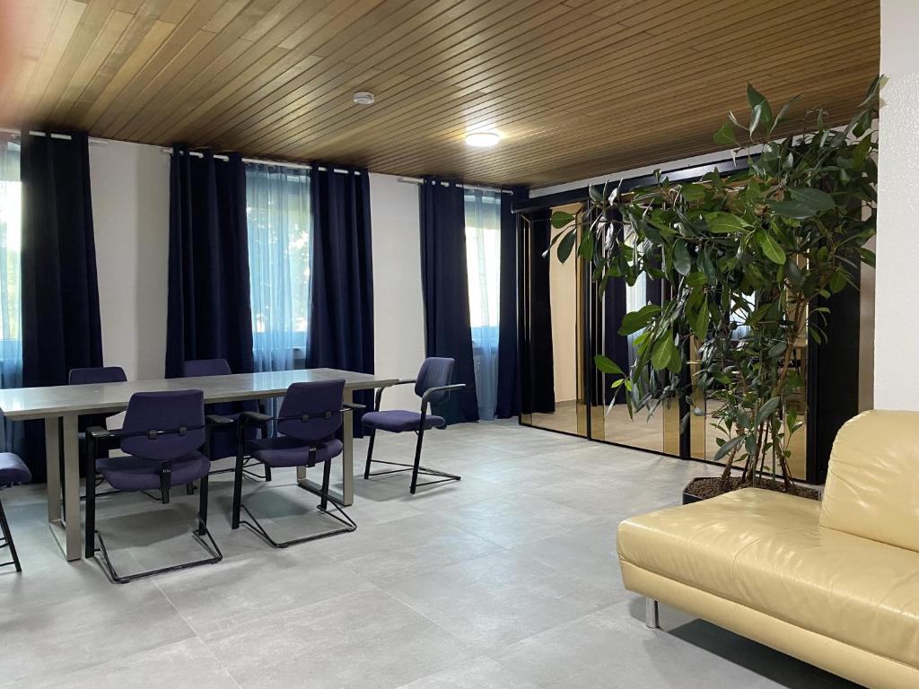 a dining room with a table and chairs and a couch at Kaiserswerth in Düsseldorf