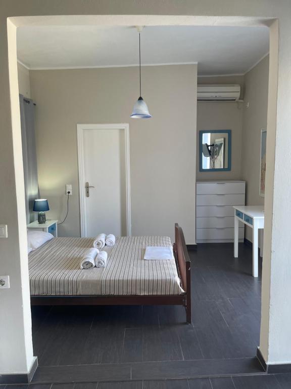 a bedroom with a bed with towels on it at AEGEAN VIEW SEASIDE ROOMS AND STUDIOS KEA in Korissia
