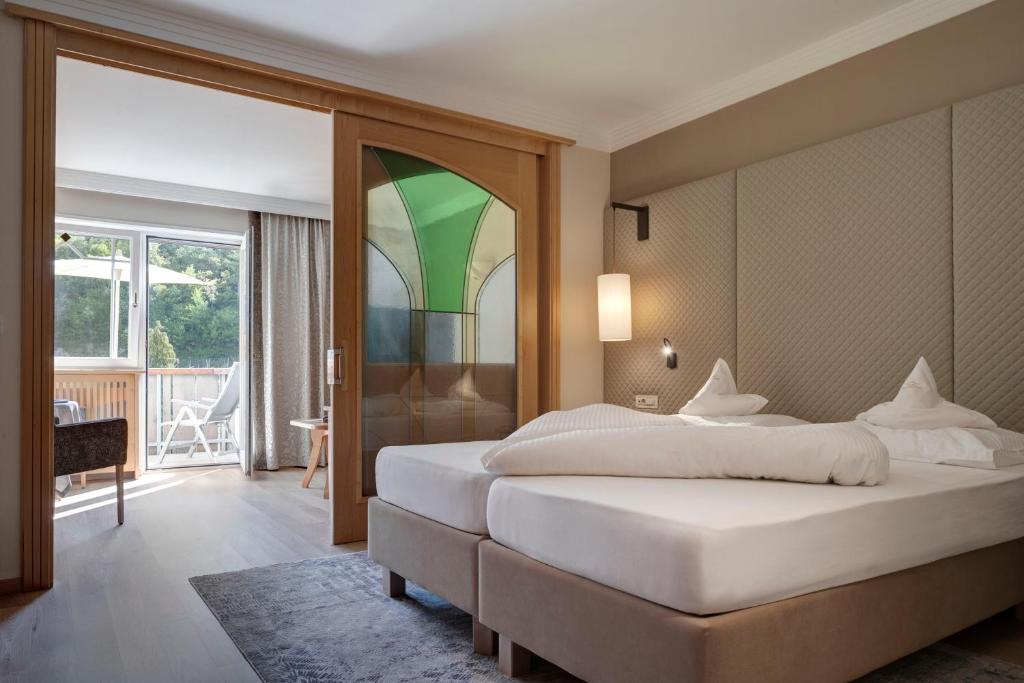 Postel nebo postele na pokoji v ubytování Hotel Burggräflerhof
