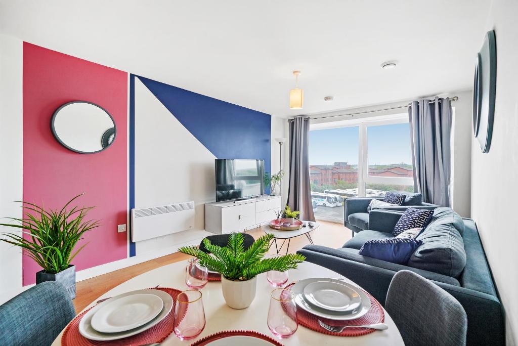 a living room with a couch and a table at Stunning 2 Bedroom Apartment in Leeds