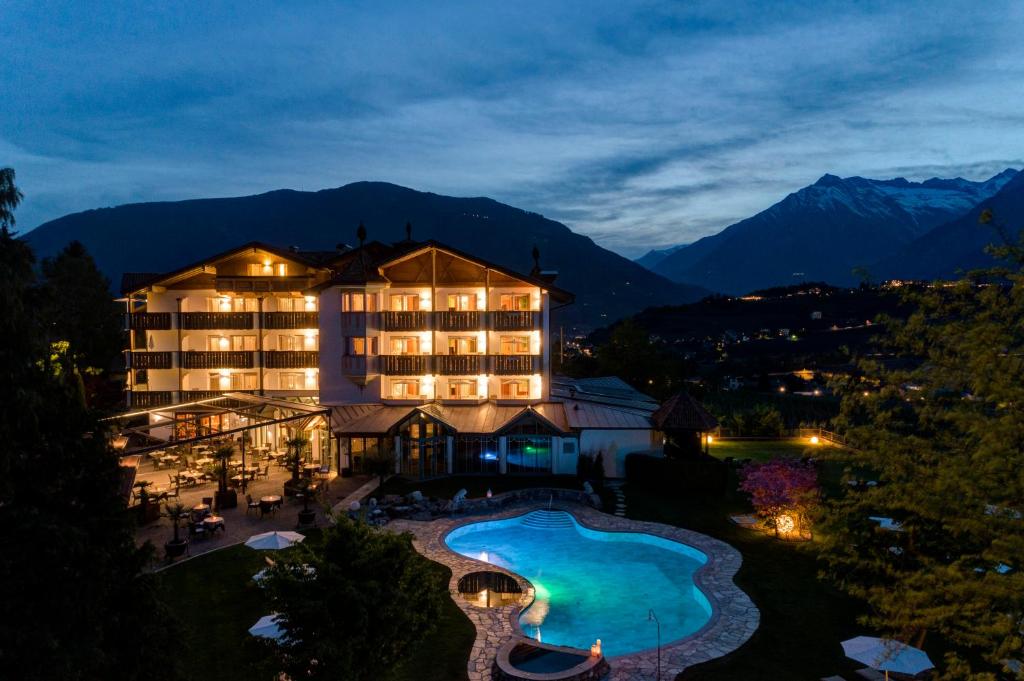 an aerial view of a hotel with a swimming pool at Hotel Burggräflerhof in Merano