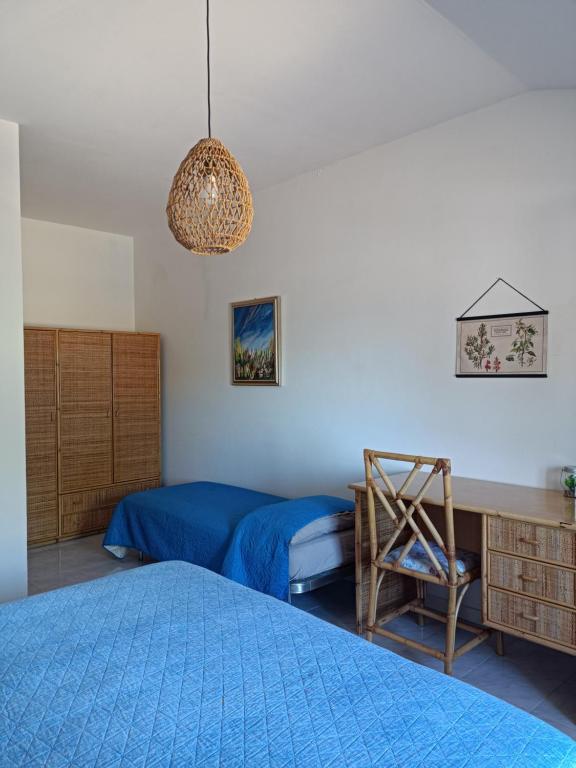 Montarice的住宿－Casa Olea，一间卧室配有两张床、一张桌子和一把椅子