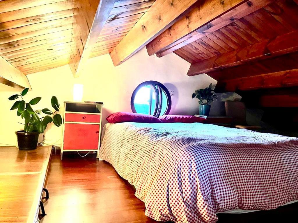 a bedroom with a bed and a wooden ceiling at Casa de las Mariposas in Vallirana