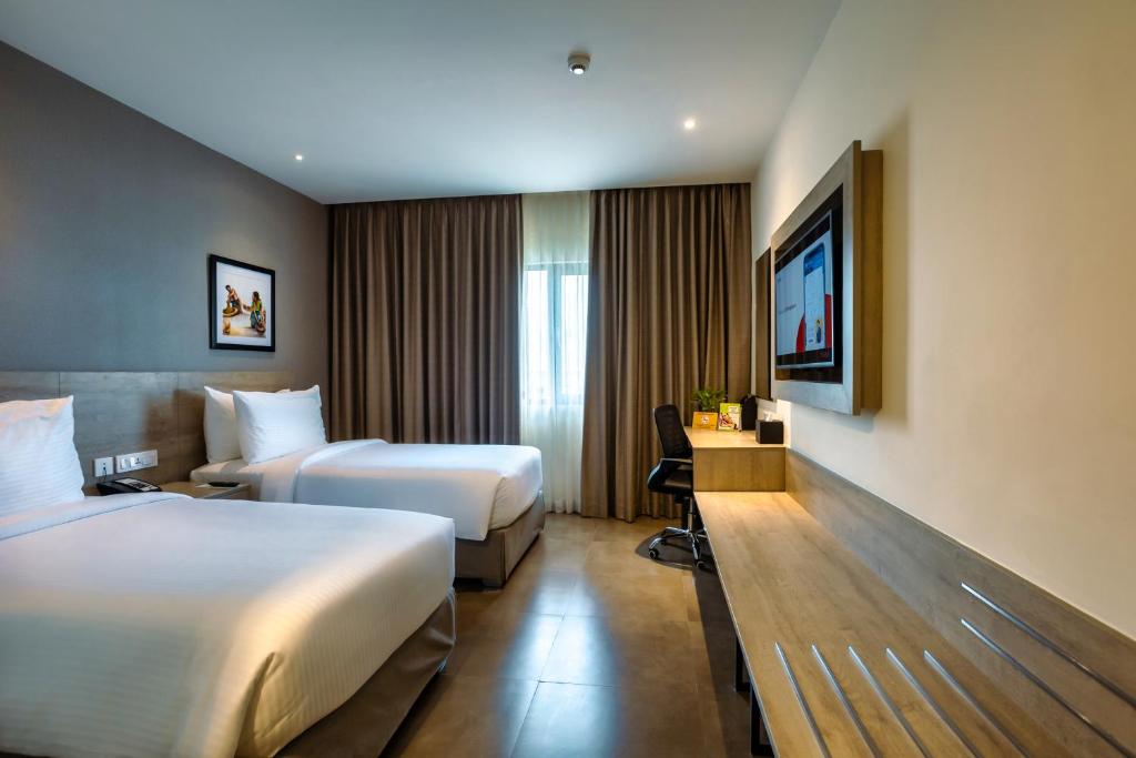Postel nebo postele na pokoji v ubytování Amika Hotel,Madurai - Near Airport