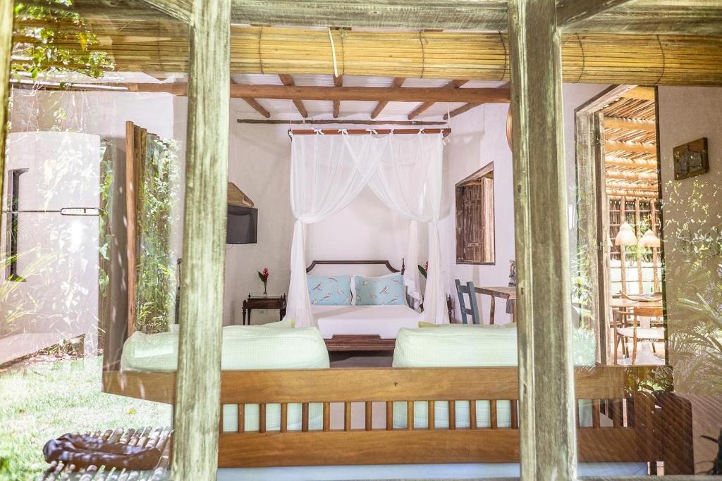 a bedroom with two beds and a window at ViverTrancoso in Trancoso