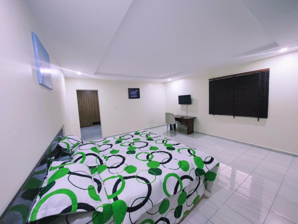 a bedroom with a bed and a tv in it at Abuja Modern Apartments in Abuja
